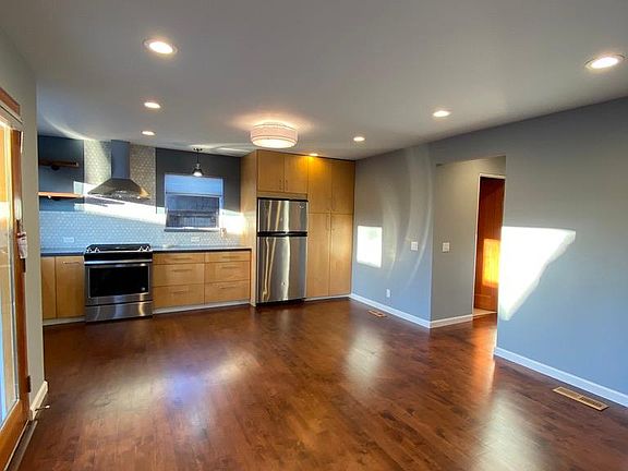 Kitchen and living room with new hardwood floors and new remodeled kitchen