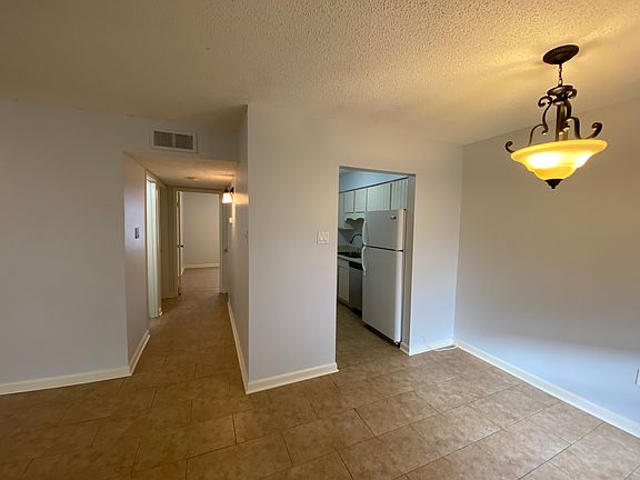 Living/Dining room with view of kitchen and hallway