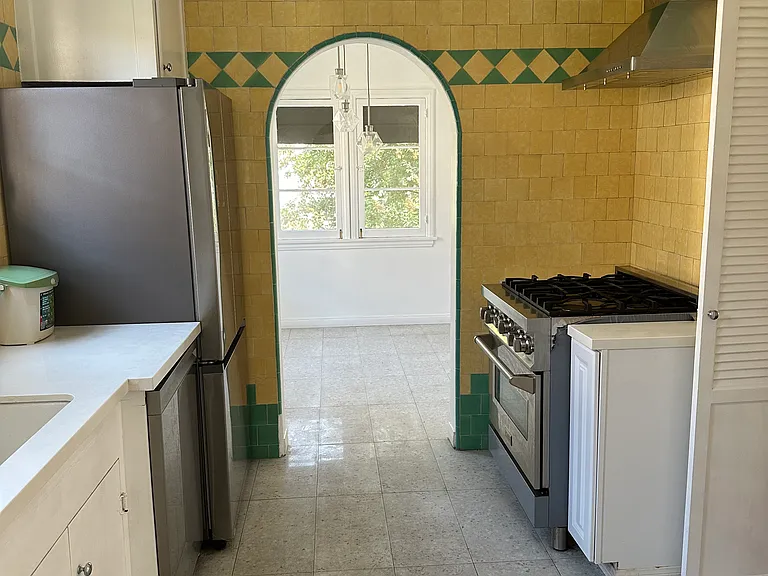 Gas range & oven, hood, dishwasher, French door refrigerator, corian countertops, disposal, terrazzo tiles