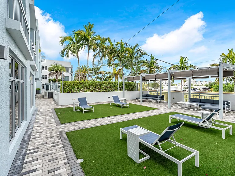 Tree-Lined Lounge Courtyard with Paved Walkways and Multiple Seating Zones