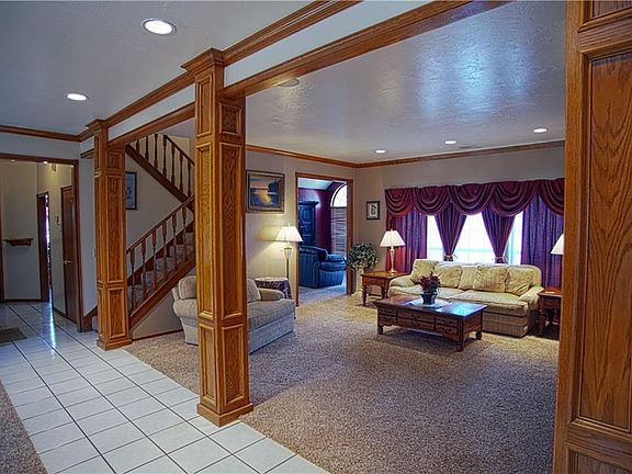 View of stairs and entry of hallway leading to laundry room/ kitchen and entry to family room