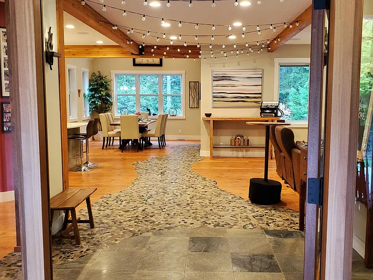 A river runs through it, welcomes you at the front door and flows to the door to the covered deck, hottub and concrete patio.