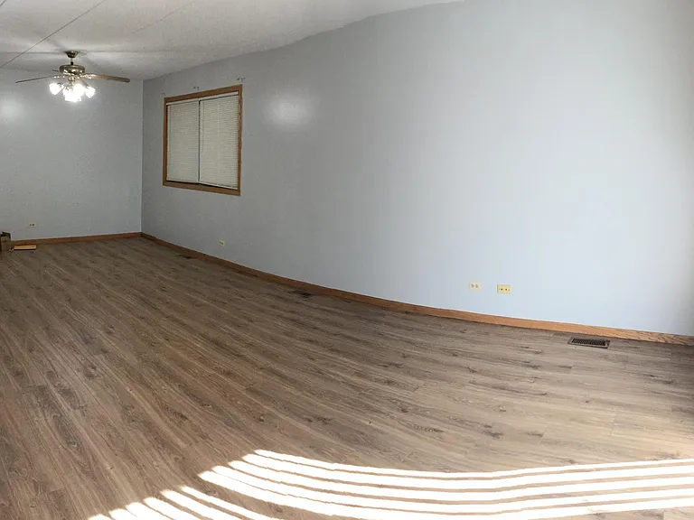 Sunny living space with hardwood like flooring