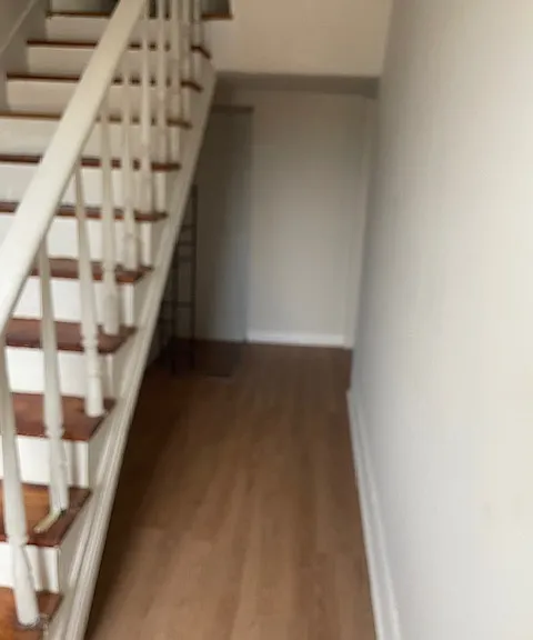 downstairs hallway/extra storage area and stairs to bedrooms on second floor