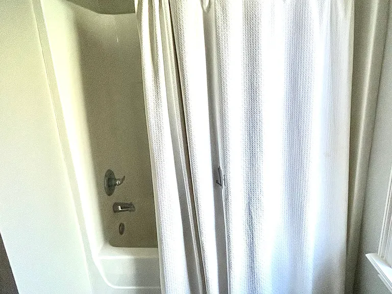 Second bath with shower/tub combo, storage under the sink and to the left of the shower.