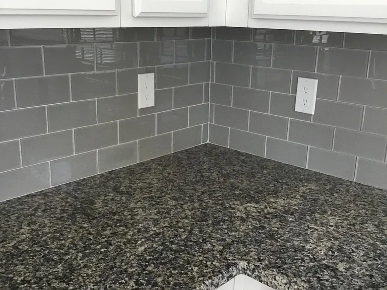 Glass subway tiled backsplash, granite counters
