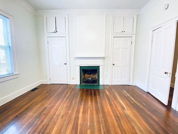 Main bedroom with decorative fireplace and two closets - 13'x14'