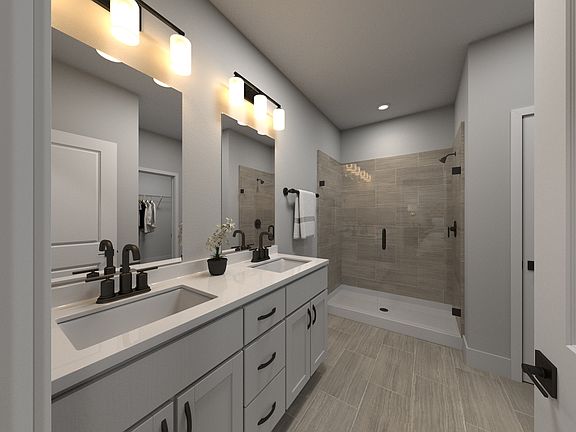 The primary bathroom offers dual vanity sinks and a walk-in closet.