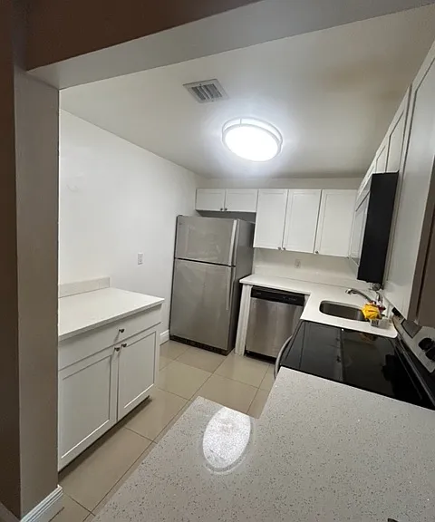 view of kitchen, has white cabinets with SS appliances