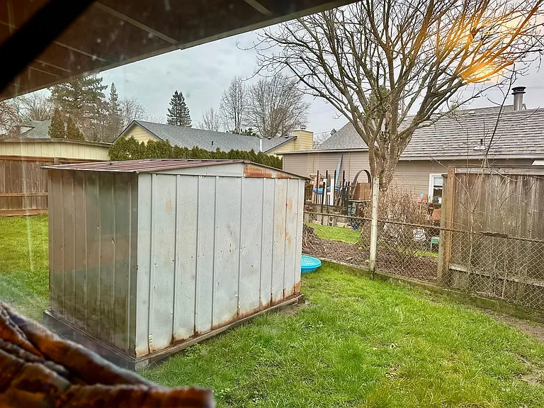Small shed in Private Side yard, view from Larger bedroom.