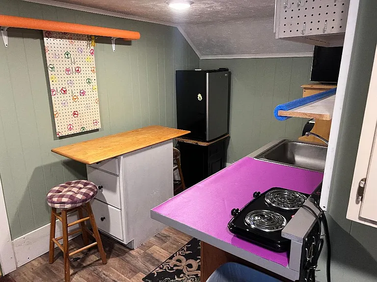2nd floor kitchen with small fridge, microwave, small electric oven and dual burner cook top. There is not a fulol size oven.