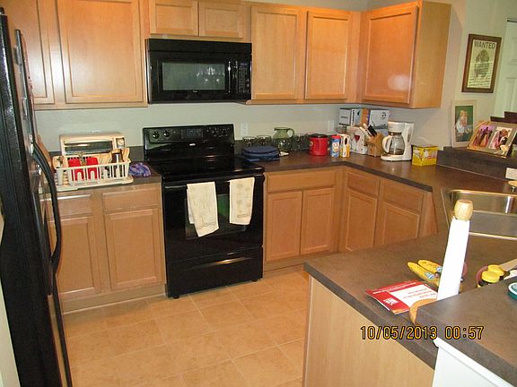 Kitchen has double sink, microwave and dishwasher.