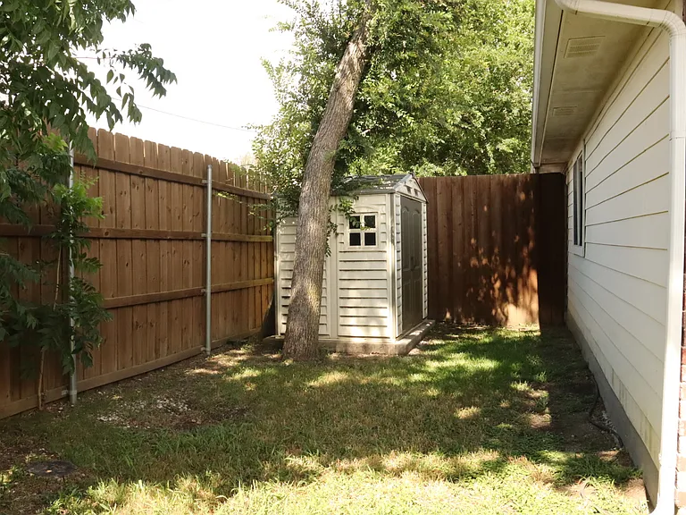 Backyard with shed for storage.