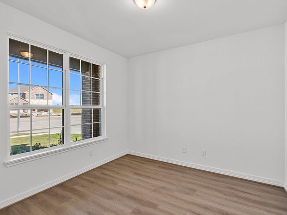 Private study with French doors, beautiful flooring, and large windows-perfect for work, creativity,