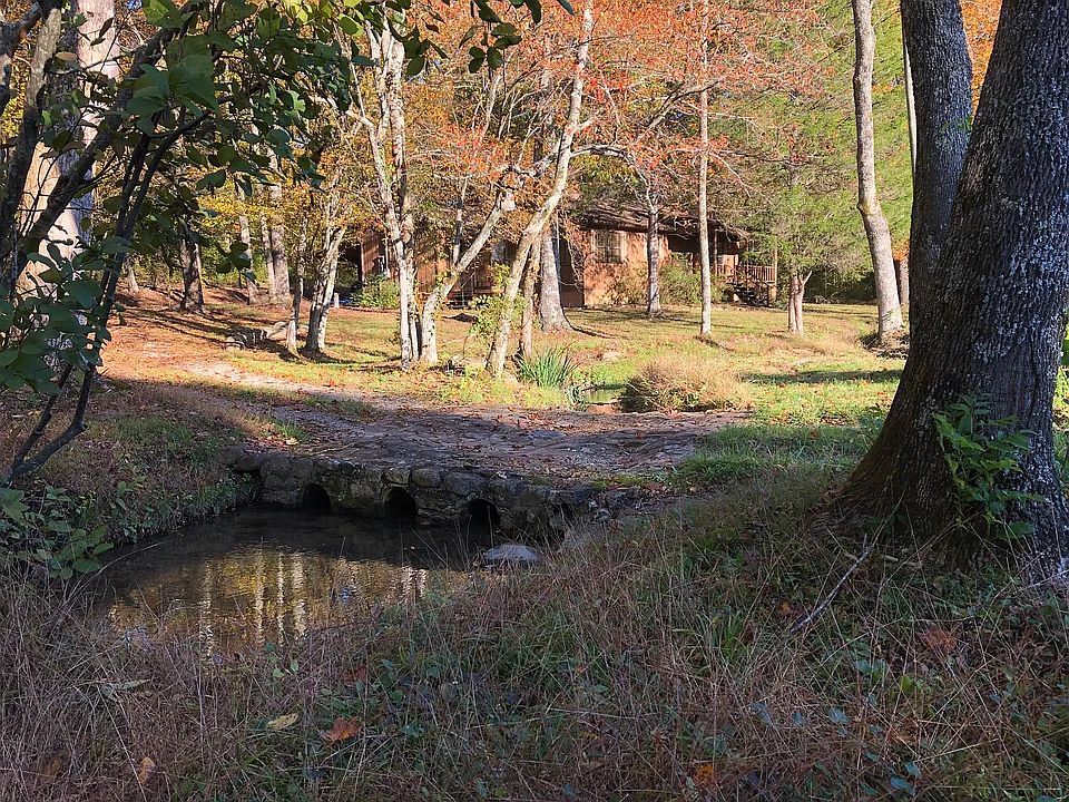 House with creek in foreground.
