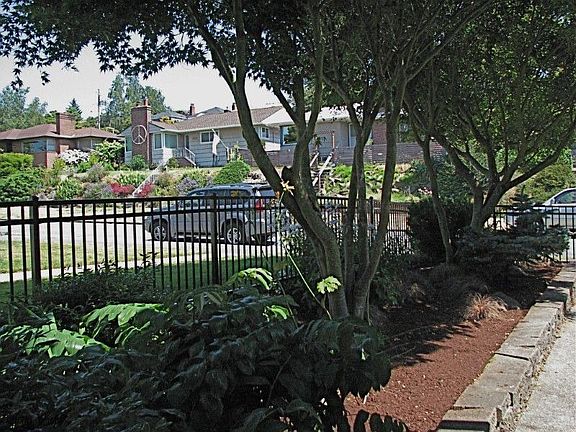 Lush, mature landscape and iron fencing provides secure, private in-city retreat!