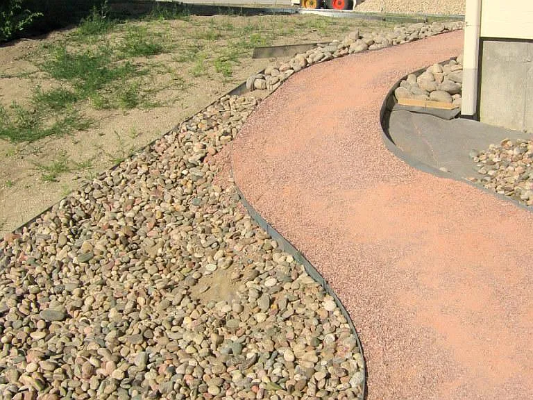 Path on the north side of the house showing the installation of new materials.