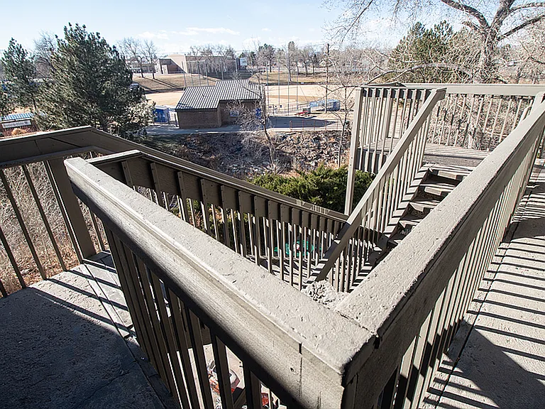 Inviting staircase with scenic views of lush park and sports fields, perfect for enjoying outdoor ambiance.