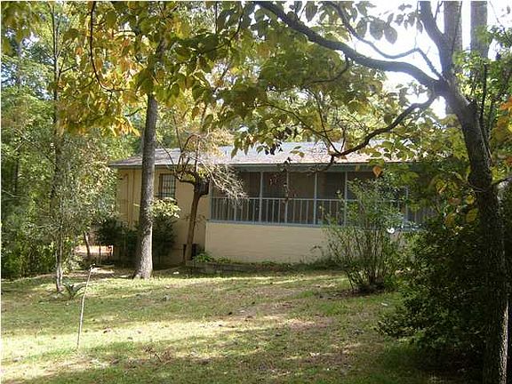 Screened back porch looking over nice wooded yard.