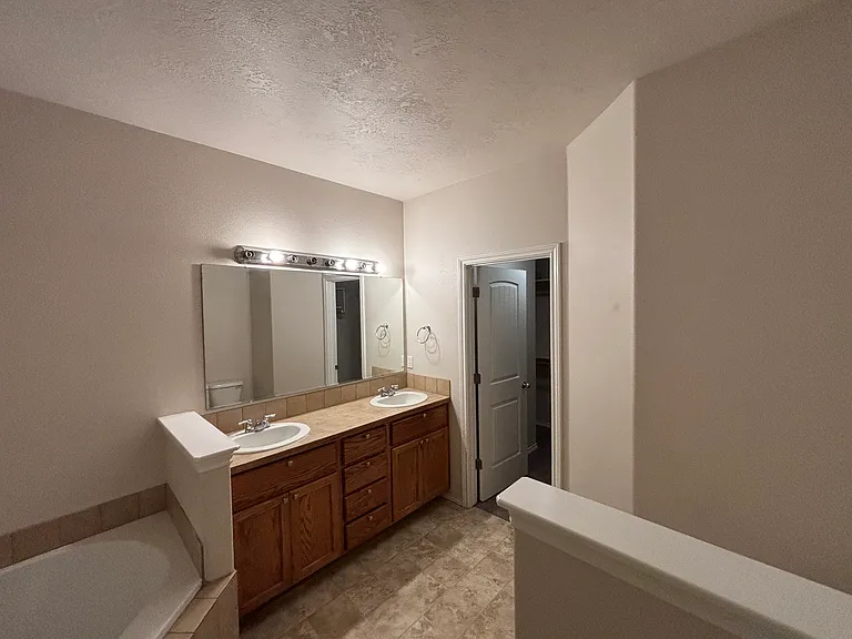 Primary bathroom with a bathtub and shower