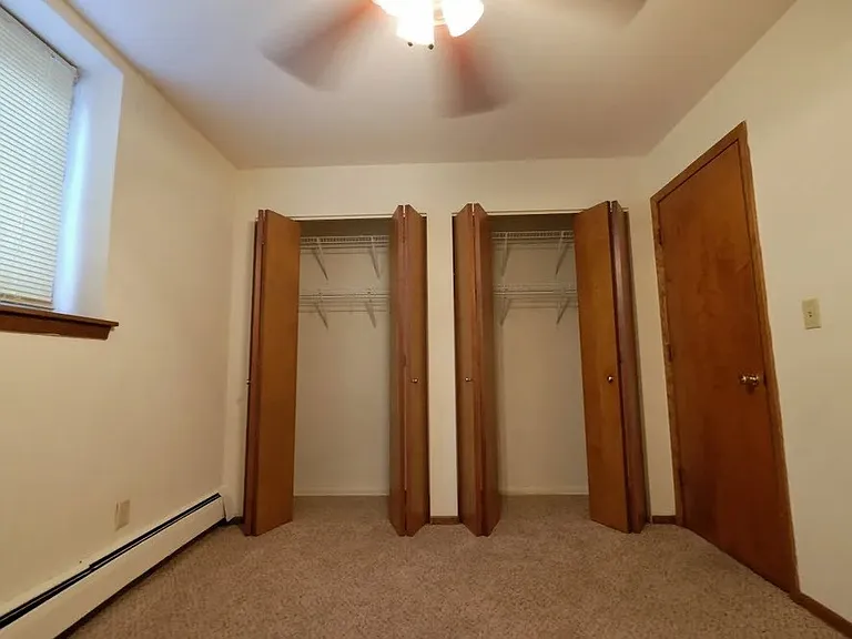 Welcome to a spacious bedroom at Central Lakes of Uptown, featuring generous closet space and cozy carpeted floors. Enjoy comfort and accessibility in a vibrant community. Schedule your visit today to see your new home!