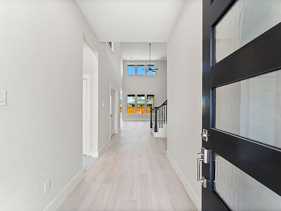 Grand foyer with soaring high ceilings, creating a luxurious and inviting entrance!