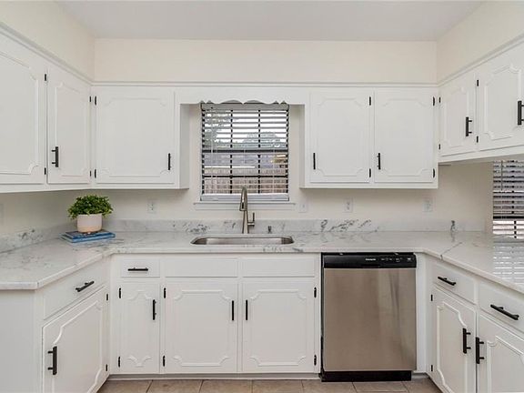 Kitchen with stainless appliances and under mount sink.