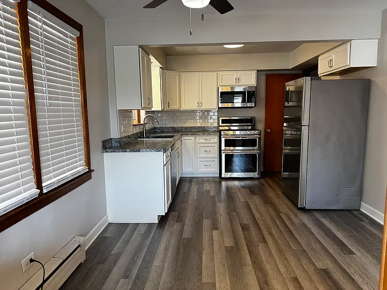 stunning new kitchen with upgraded stainless steel appliances and dinning area