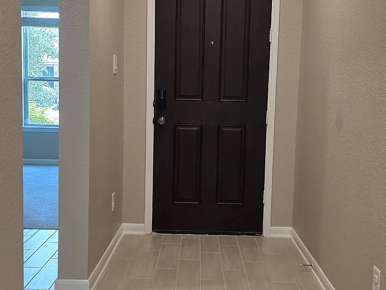 Open and welcoming entryway with clean tile flooring