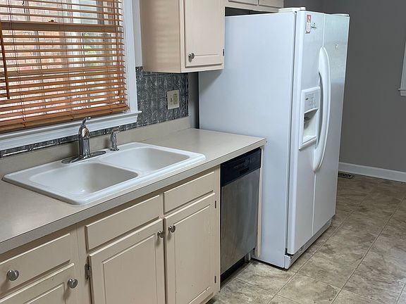 kitchen sink, dishwasher, and side by side refrigerator