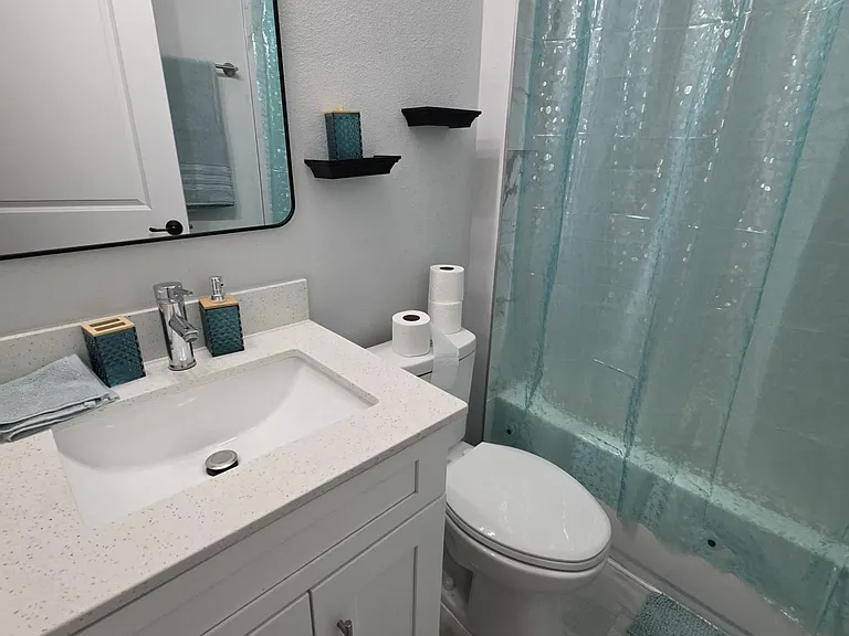 Full bath with a wide vanity, ample cabinet storage, and a shower/tub combo for everyday convenience.