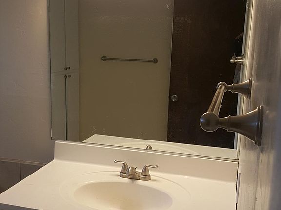 Spacious bathroom with new tile and fixtures. Also, large linen cabinet