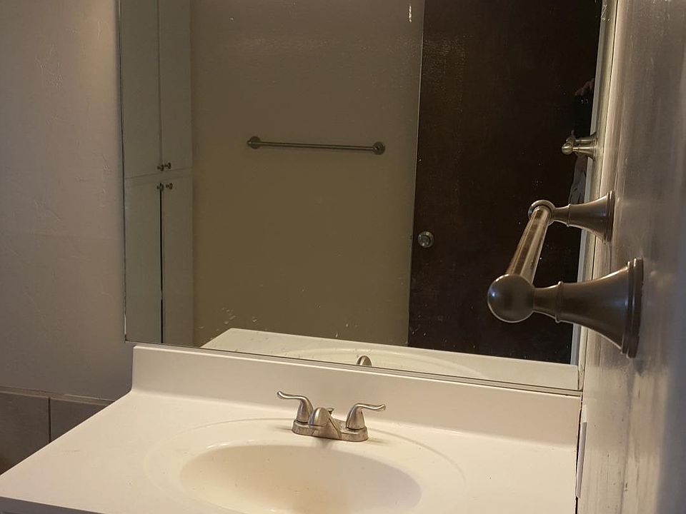 Spacious bathroom with new tile and fixtures. Also, large linen cabinet