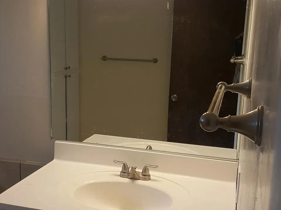 Spacious bathroom with new tile and fixtures. Also, large linen cabinet