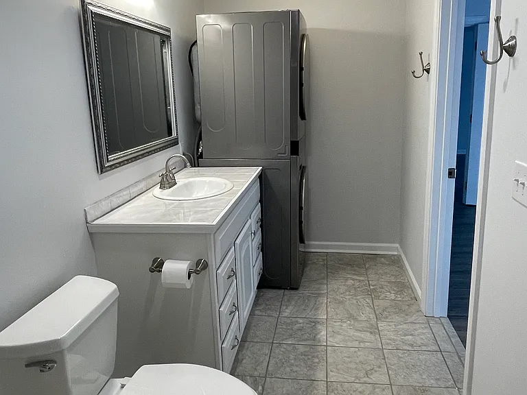 The LG stacked washer and dryer unit is located in the bathroom.