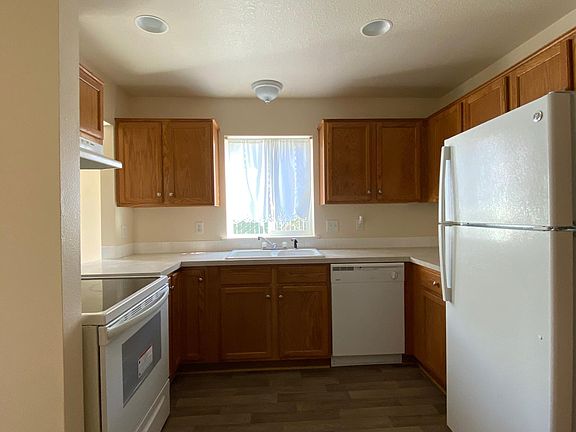 Kitchen with recently added refrigerator, glass top range and dishwasher