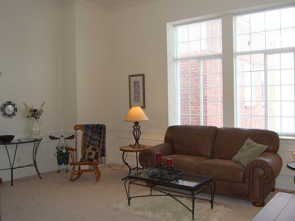Huge living room has 12' ceilings and a wall of windows