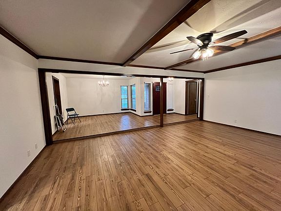 Front door and living room. Room with double windows can be a formal dining room, play room, study, pool table or office.