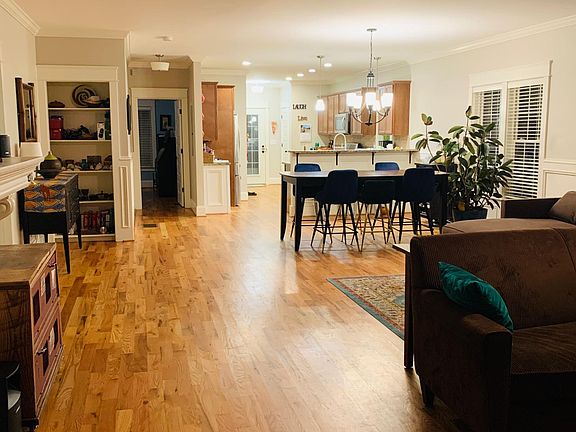 Open concept living, reading nook, dining, and kitchen with a breakfast bar