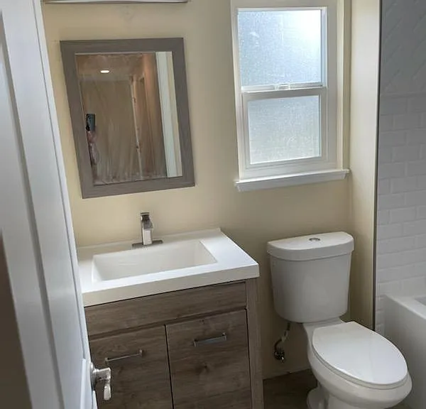 Highly Upgraded Bathroom: Vanity with Quartz Counter-Top, and Fully Tiled Shower/ Bath