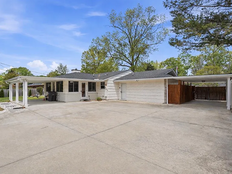 Spacious backyard with extra paved driveway.