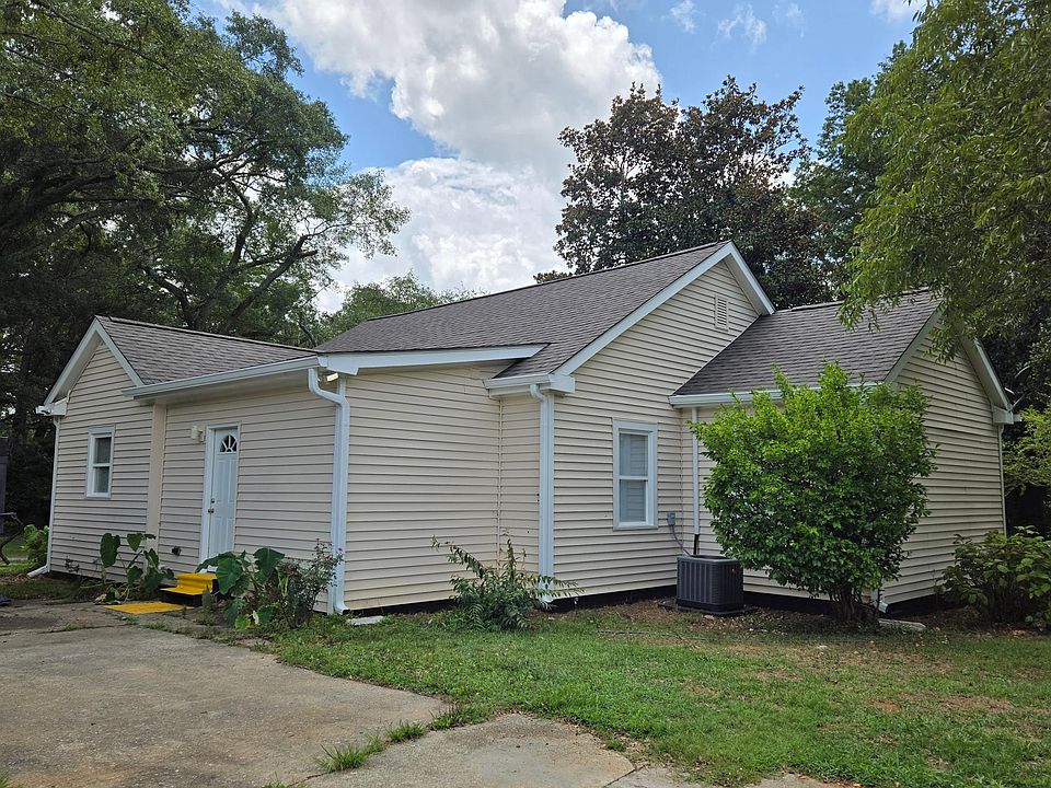 Back of home. Driveway entrance. Opens into mud / laundry room.