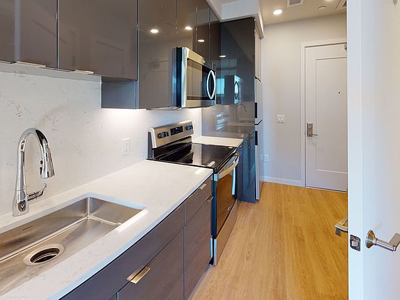 Quartz countertops and modern high-gloss custom cabinetry