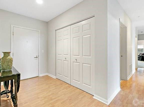 The welcoming foyer has a large guest closet and easy care Pergo floors that look like hardwood and 