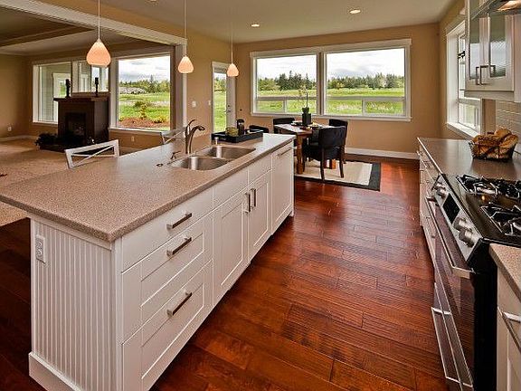 Kitchen island showing view to golf course and attached dining area.