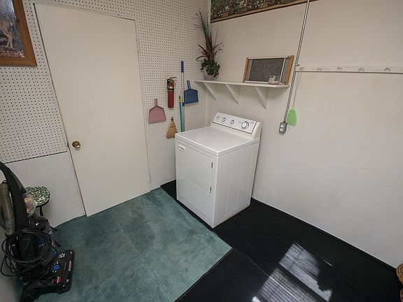 Entering into the home from the back door, you are met with a utility room. This room houses the dryer, and is a great space to hang coats and store shoes. 