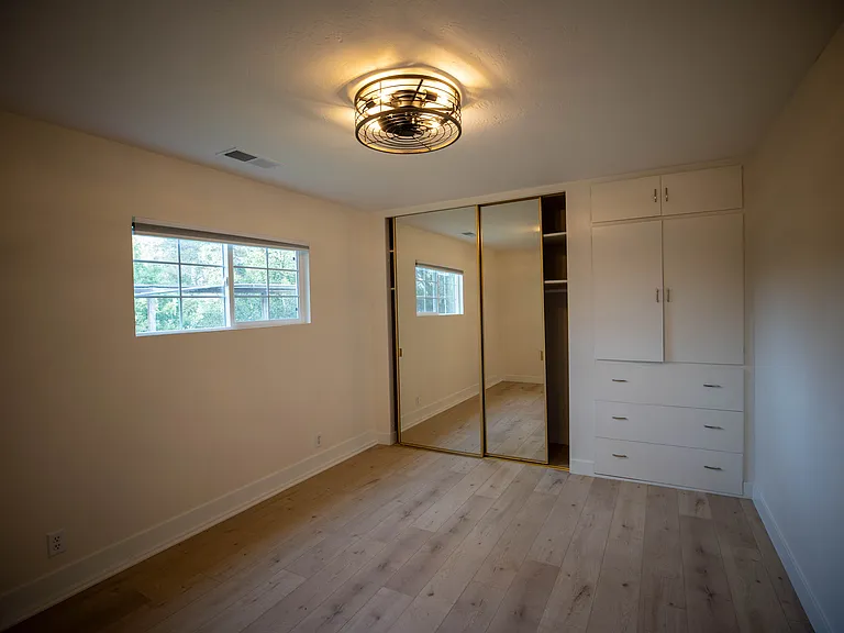 Bedroom with built in drawers and cabinets. Also new sliding doors with rods and shelves.