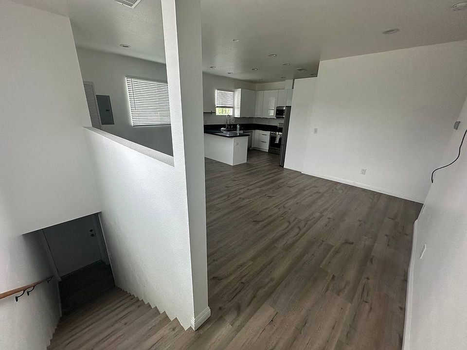 Stairs + open concept living/dining/kitchen area