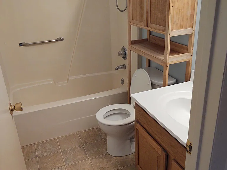 Main bathroom showing bamboo storage cabinet