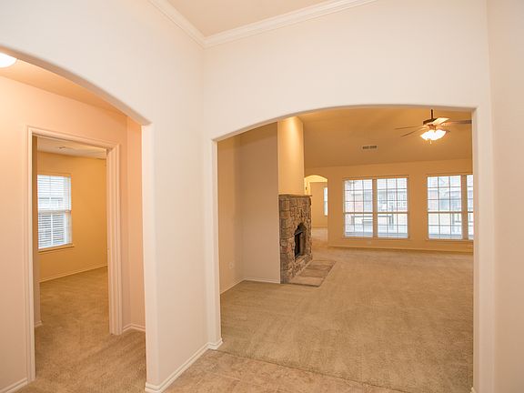 View of great room with stone fireplace and wall of windows from entry.